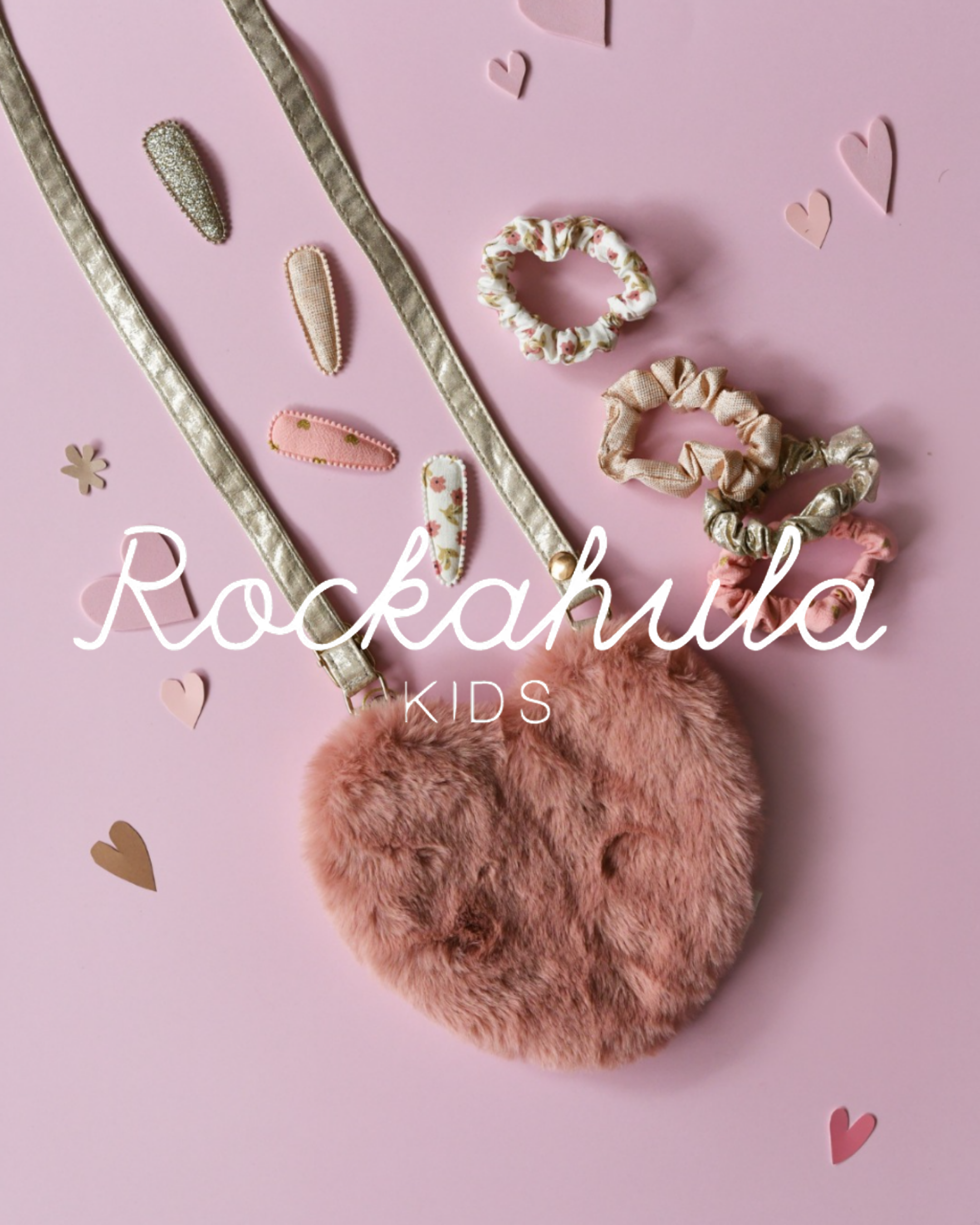 Rockahula Kids pink fluffy bag, floral scrunchies, gold hair clips on pink background with heart decorations